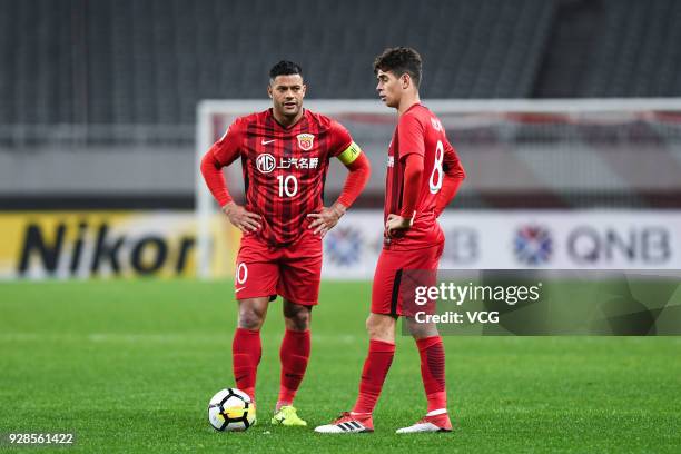 Hulk and Oscar of Shanghai SIPG prepare for a free kick during the AFC Champions League Group F match between Shanghai Shenhua and Ulsan Hyundai at...