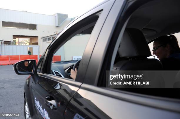 Saudi woman has a driving lesson in Jeddah on March 7, 2018. Saudi Arabia's historic decision in September 2017 to allow women to drive from June has...