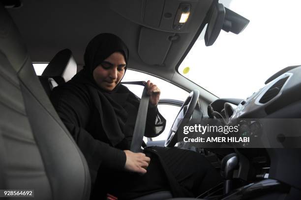 Saudi woman puts on her seatbelt during a driving lesson in Jeddah on March 7, 2018. Saudi Arabia's historic decision in September 2017 to allow...