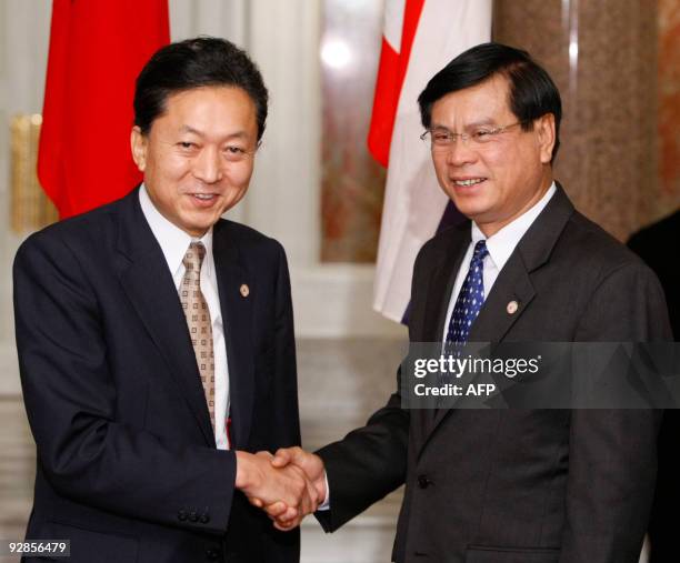 Lao's Prime Minister Bouasone Bouphavanh shakes hands with Japan's Prime Minister Yukio Hatoyama at the state guest house in Tokyo November 6, 2009....