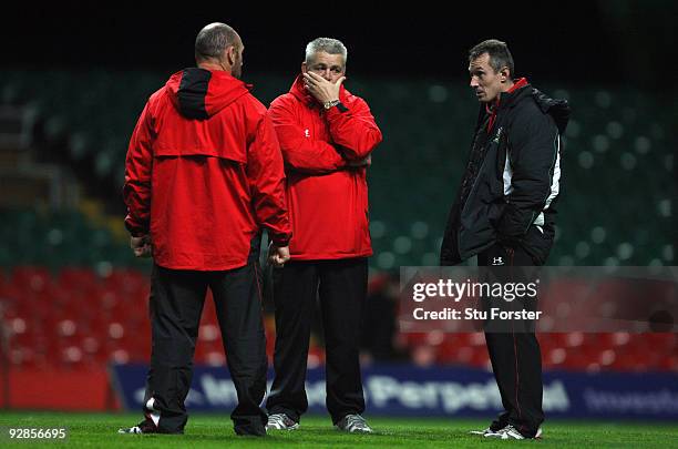 Wales coaches from left Robyn Mcbride, Warren Gatland and Robert Howley chat during Wales Rugby training at the Millennium stadium on November 6,...