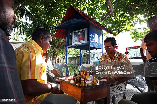 Local men playing chess on a central place and meeting point with television for everyone in a village on September 27, 2009 on Fedu Island,...