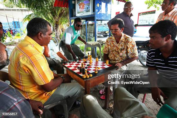 Local men playing chess on a central place and meeting point with television for everyone in a village on September 27, 2009 on Fedu Island,...