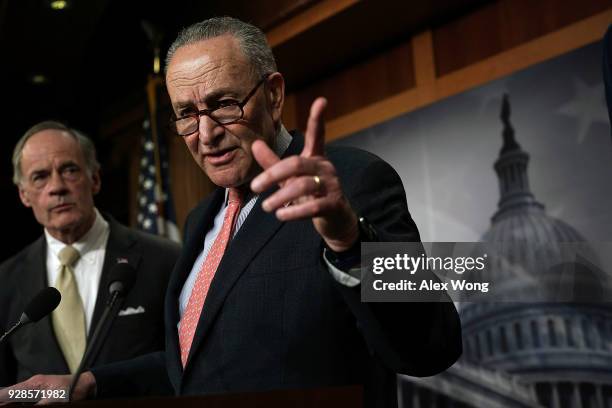 Senate Minority Leader Sen. Chuck Schumer speaks as Sen. Tom Carper listens during a news conference at the Capitol March 7, 2018 in Washington, DC....