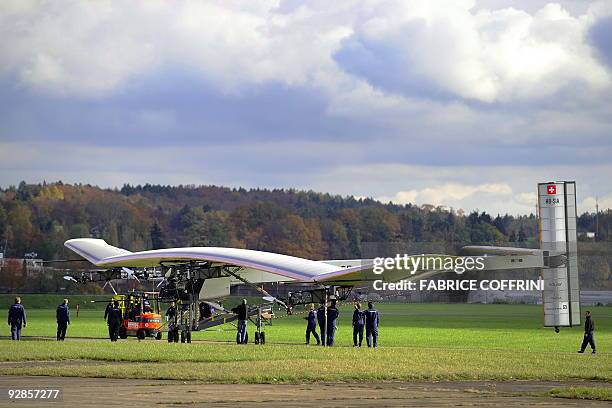 An aircraft dubbed 'Solar Impulse', HB-SIA prototype, is rolled out of a hangar for an initial series of stationary tests involving engines and...