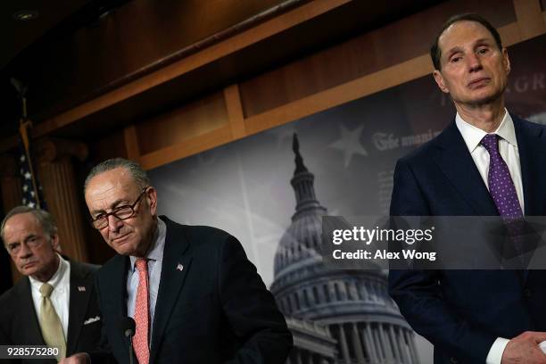 Senate Minority Leader Sen. Chuck Schumer , Sen. Tom Carper and Sen. Ron Wyden listen during a news conference at the Capitol March 7, 2018 in...