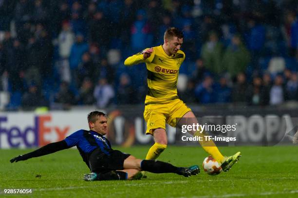 Rafael Toloi of Bergamo and Marco Reus of Dortmund battle for the ball during UEFA Europa League Round of 32 match between Atalanta and Borussia...