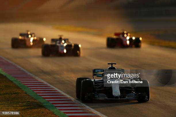 Valtteri Bottas driving the Mercedes AMG Petronas F1 Team Mercedes WO9 leads three cars during a practice start during day two of F1 Winter Testing...