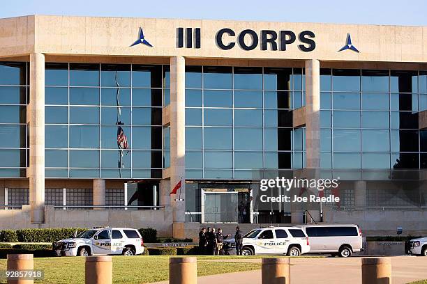 Police vehicles are parked in front of the headquarters building at Fort Hood where at another location on base U.S. Army Major Nidal Malik Hasan...