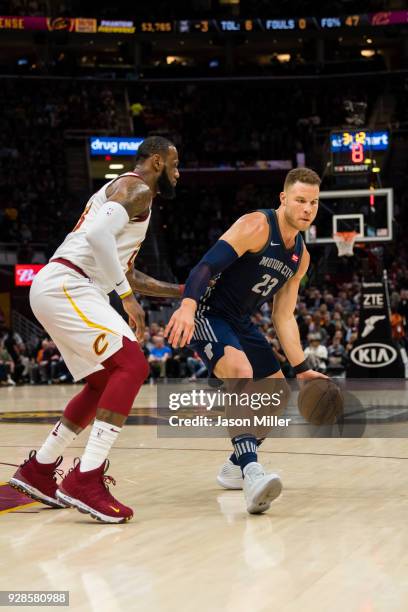 LeBron James of the Cleveland Cavaliers guards Blake Griffin of the Detroit Pistons during the first half at Quicken Loans Arena on March 5, 2018 in...