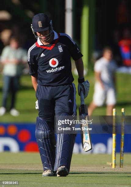 Jonathan Trott of England walks off holding his right leg after his dismissal during the tour match between the Diamond Eagles and England at the...