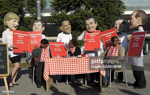 Members of anty-poverty group Oxfam wearing masks of world leaders German Chancellor Angela Merkel, British Prime Minister Gordon Brown, US President...