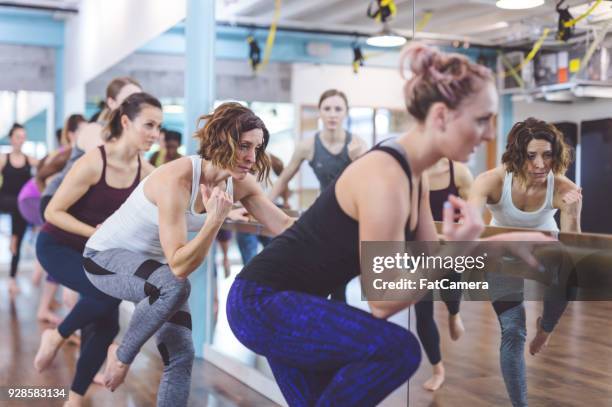 women doing barre workout together - pike position stock pictures, royalty-free photos & images