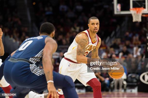 Andre Drummond of the Detroit Pistons guards George Hill of the Cleveland Cavaliers during the second half at Quicken Loans Arena on March 5, 2018 in...