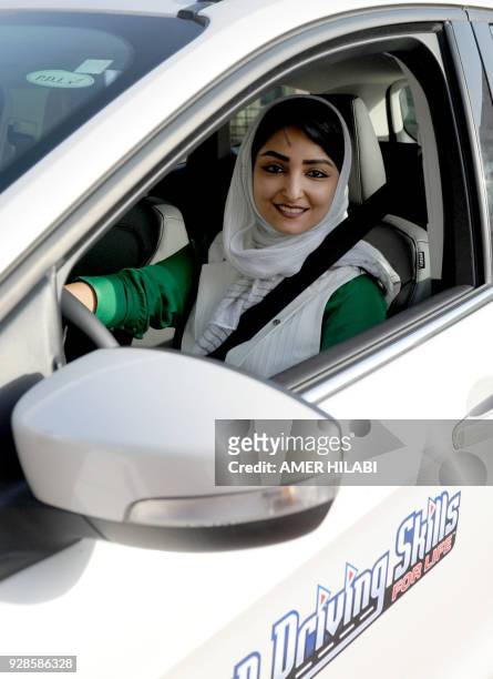 Saudi woman poses for a photo as she has a driving lesson in Jeddah on March 7, 2018. Saudi Arabia's historic decision in September 2017 to allow...