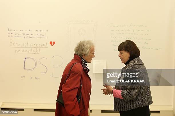 Visitors chat in front of a wall in the Scheringa Museum for Realist in Spanbroek which has opened its doors on Wednesday, October 21 even though...