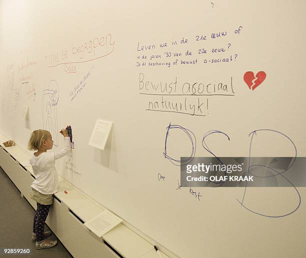 Small girl paints the wall in the Scheringa Museum for Realist in Spanbroek which has opened its doors on Wednesday, October 21 even though half of...