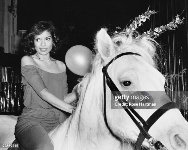Bianca Jagger rides in on a white horse at during her birthday celebrations at Studio 54 in New York, May 1977.