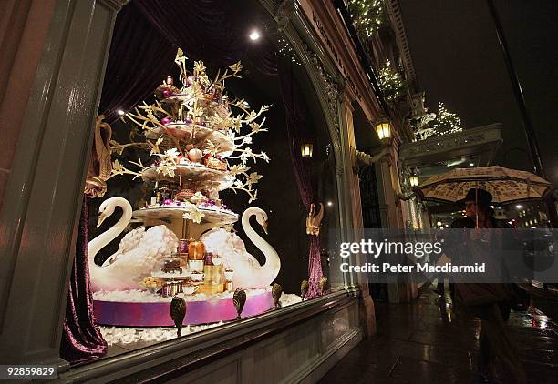 Shopper walks past a newly unveiled Christmas window of Fortnum & Mason grocery store on November 6, 2009 in Picadilly, London. Shops are preparing...