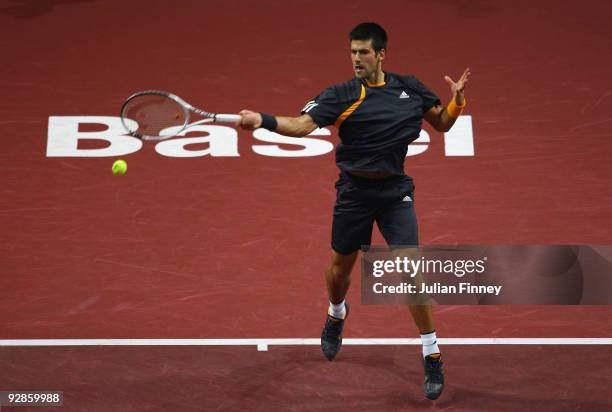 Novak Djokovic of Serbia in action against Stanislas Wawrinka of Switzerland during Day Five of the Davidoff Swiss Indoors Tennis at St Jakobshalle...