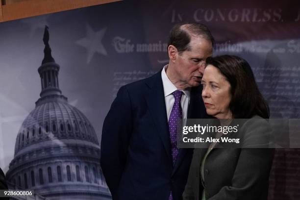 Sen. Maria Cantwell listens to Sen. Ron Wyden during a news conference at the Capitol March 7, 2018 in Washington, DC. Senate Democrats held a news...