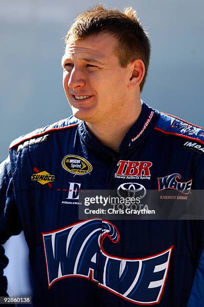 Michael McDowell, driver of the my123backup.com Dodge, stands in the garage area during practice for the NASCAR Nationwide Series O'Reilly Challenge...