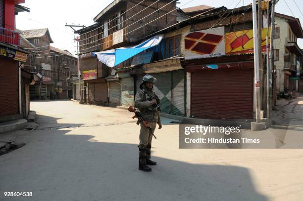 Paramilitary soldier stands guard during restriction on March 7, 2018 in downtown area of Srinagar, India. Authorities today imposed restrictions in...