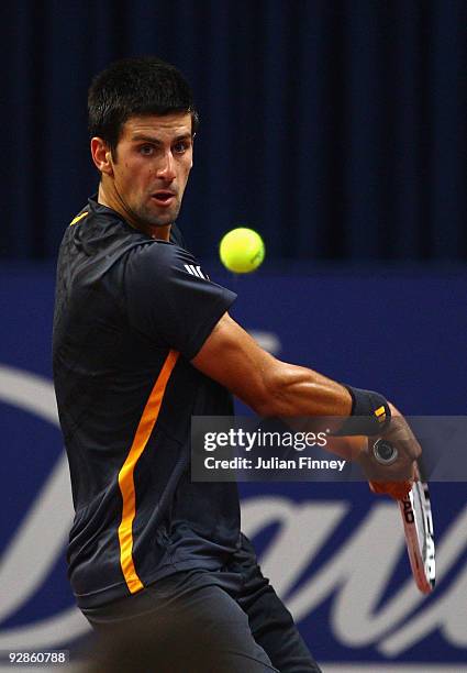 Novak Djokovic of Serbia in action against Stanislas Wawrinka of Switzerland during Day Five of the Davidoff Swiss Indoors Tennis at St Jakobshalle...