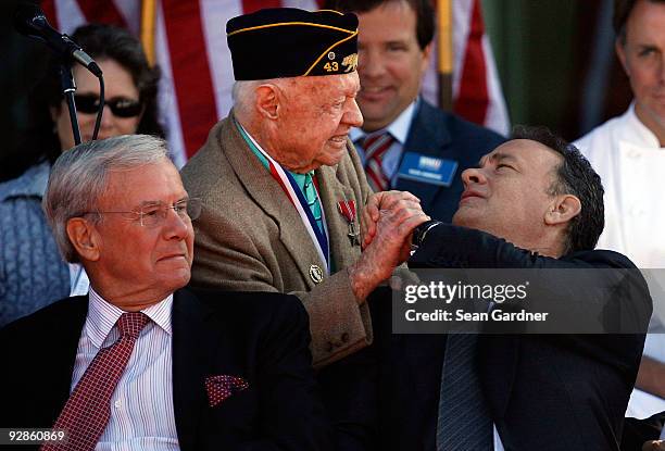 Tom Hanks shakes hands with Mickey Rooney as Tom Brokaw looks on during the National World War II Museum Dedication Ceremony on November 6, 2009 in...