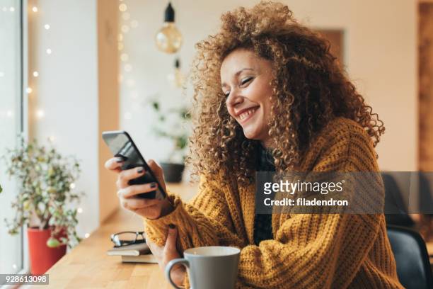 pretty woman texting on the phone - choosing stock pictures, royalty-free photos & images