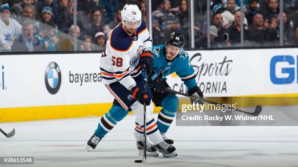 Anton Slepyshev of the Edmonton Oilers skates with the puck against Mikkel Boedker of the San Jose Sharks at SAP Center on February 27, 2018 in San...