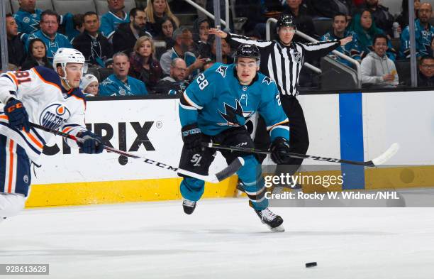 Timo Meier of the San Jose Sharks skates after the puck agaoinst Yohann Auvitu of the Edmonton Oilers at SAP Center on February 27, 2018 in San Jose,...