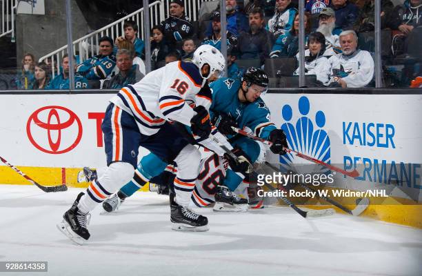Tomas Hertl of the San Jose Sharks skates after the puck against Jujhar Khaira and Anton Slepyshev of the Edmonton Oilers at SAP Center on February...