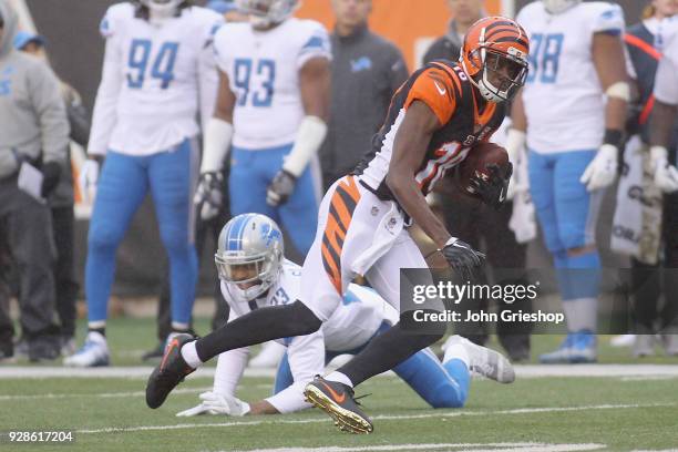 Green of the Cincinnati Bengals runs the football upfield against Darius Slay of the Detroit Lions during their game at Paul Brown Stadium on...