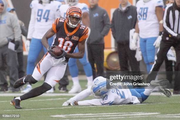 Green of the Cincinnati Bengals runs the football upfield against Darius Slay of the Detroit Lions during their game at Paul Brown Stadium on...