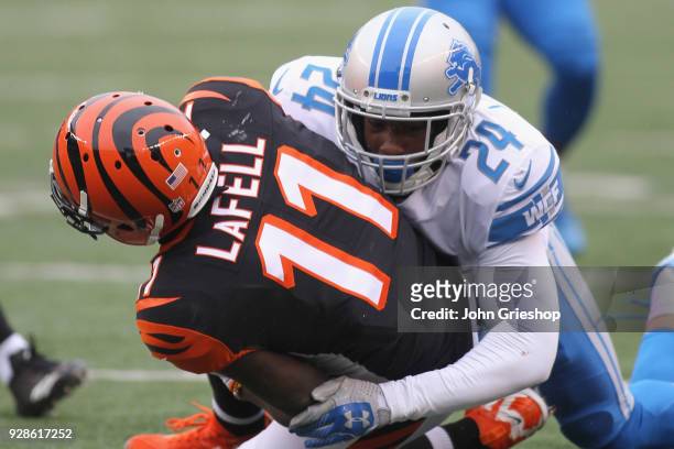 Brandon LaFell of the Cincinnati Bengals runs the football upfield against Nevin Lawson of the Detroit Lions during their game at Paul Brown Stadium...
