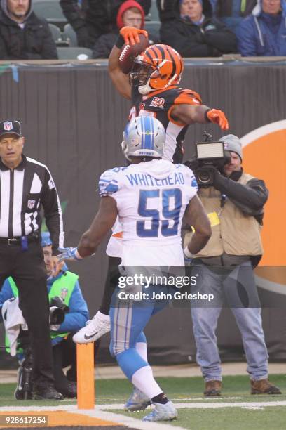 Giovani Bernard of the Cincinnati Bengals runs the football into the endzone against Tahir Whitehead of the Detroit Lions during their game at Paul...