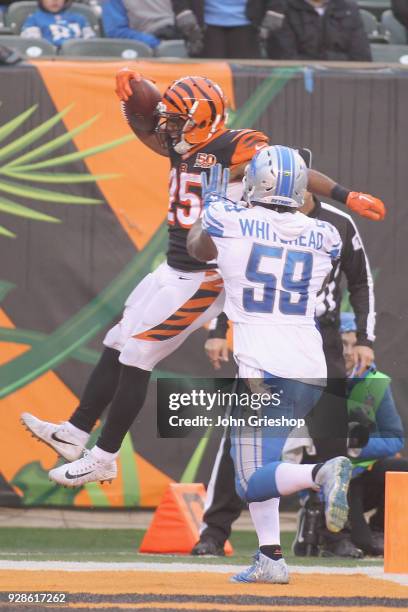 Giovani Bernard of the Cincinnati Bengals runs the football into the endzone against Tahir Whitehead of the Detroit Lions during their game at Paul...