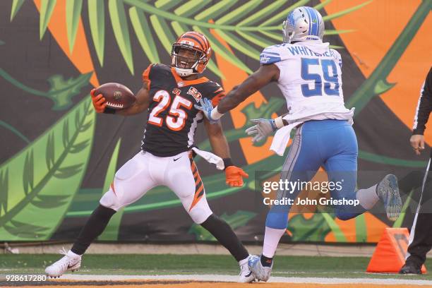 Giovani Bernard of the Cincinnati Bengals runs the football into the endzone against Tahir Whitehead of the Detroit Lions during their game at Paul...