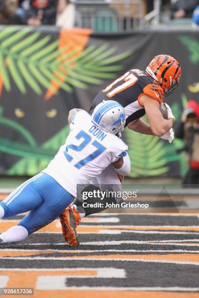 Uzomah of the Cincinnati Bengals runs the football into the endzone against Glover Quin of the Detroit Lions during their game at Paul Brown Stadium...