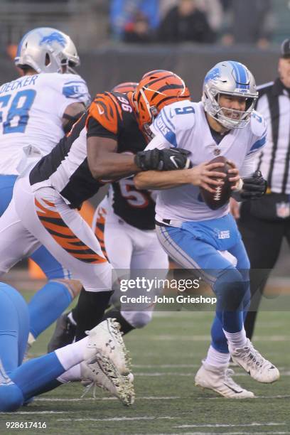 Carlos Dunlap of the Cincinnati Bengals makes the tackle on Matthew Stafford of the Detroit Lions during their game at Paul Brown Stadium on December...