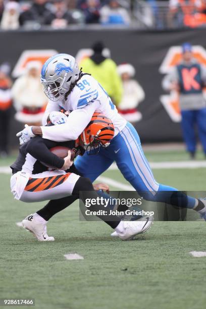 Ezekiel Ansah of the Detroit Lions sacks Andy Dalton of the Cincinnati Bengals during their game at Paul Brown Stadium on December 24, 2017 in...