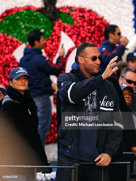 Derek Jeter of the New York Yankees and actress Minka Kelly celebrate on a float during the New York Yankees World Series Victory Parade on November...
