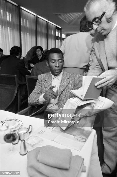 Brazilian footballer Edson Arantes do Nascimento, more famously knows as Pele, pictured signing autographs during his visit to Birmingham. February...