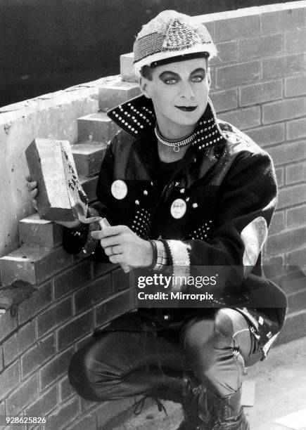 Julian Clary spends the day on a building site in London's Docklands to earn ø10,000 'wages' for charity. The money was donated by a development...