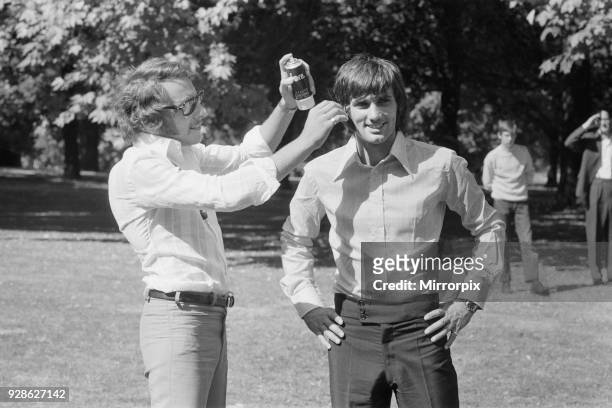Manchester United footballer George Best has hair spray applied by his personal hairdresser Malcolm Wagner in Hyde Park before acting in a television...