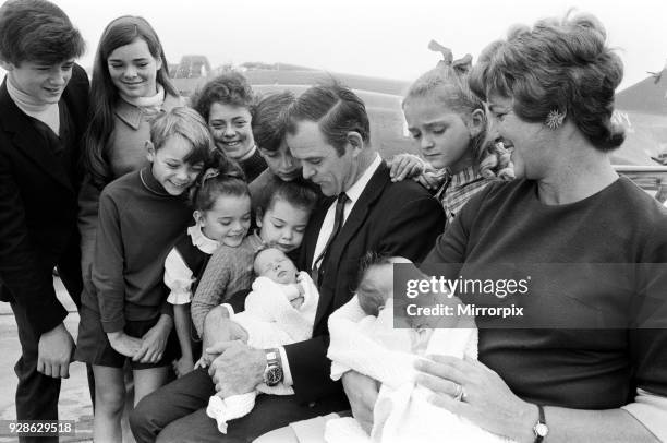 Lieutenant Commander Peter Marshall of HMS Ark Royal and his wife Carolyn, both holding their new born baby twin boys Paul and Mark, pose with their...