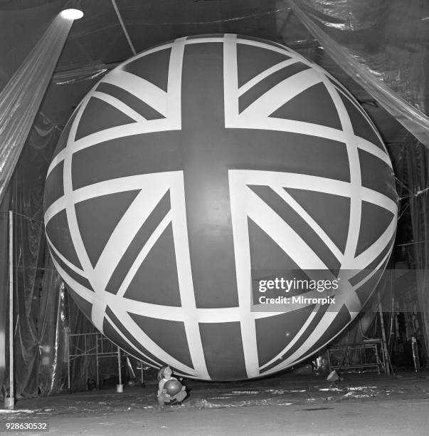 Union Jack Giant Balloon at Expo 70 Little Miss Susan Howlett, five, is dwarfed by the huge balloon destined to fly over the British pavilion at the...