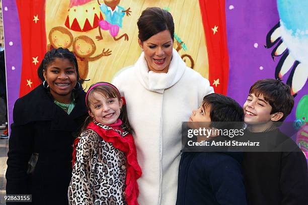 Actress Marcia Gay Harden pose for photos with children from PS 23 Brooklyn after reading The Big Book of Dreams in Rockefeller Center on November 6,...