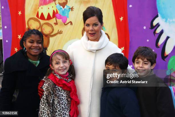 Actress Marcia Gay Harden pose for photos with children from PS 23 Brooklyn after reading The Big Book of Dreams in Rockefeller Center on November 6,...